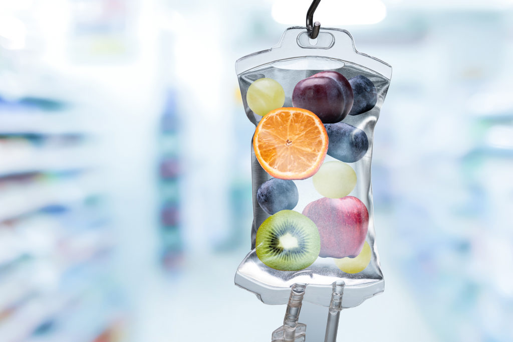 Different Fruit Slices Inside Saline Bag Hanging In Hospital